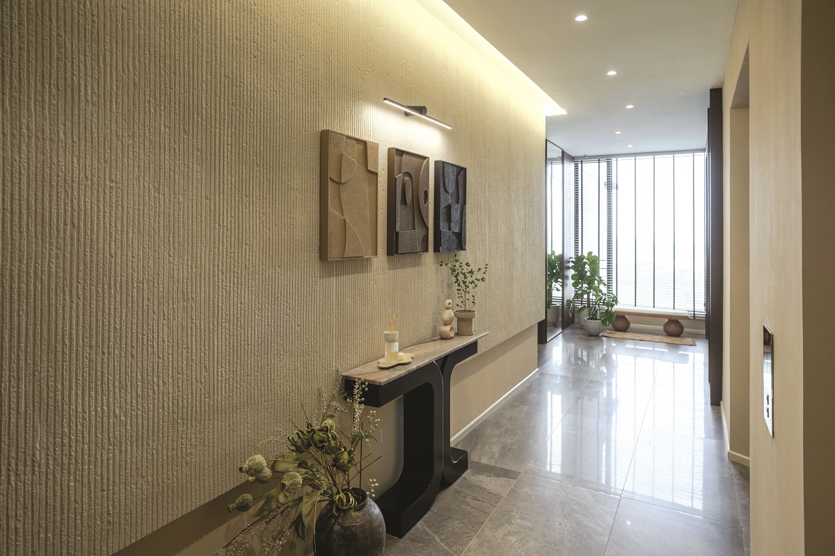 Private lift lobby: A quiet, textured entrance sets the tone for the home.